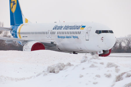 Ukraine, Kyiv - February 12, 2021: Planes at Winter. Aircraft. There is a lot of snow at the airport. Bad weather and visibility. Blocks of snow. Snowfall. There is a lot of snow at the airportのeditorial素材