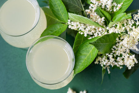 Carbonated elderflower drink. Flower summer kvass in glasses. Sparkling homemade hugo water. Buza...