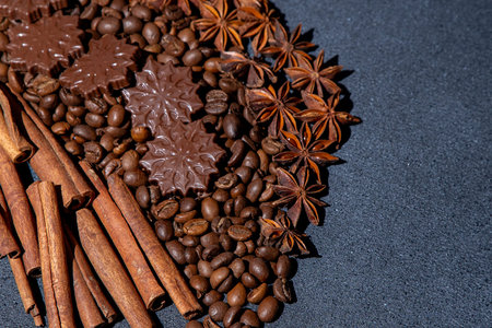 Food background. Coffee beans, cinnamon sticks, anise stars and chocolate candies.