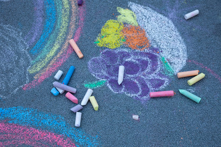 Chalk draw on the asphalt. Drawing multicolored chalks stick. Kids play outdoorの写真素材