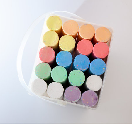 Sidewalk colored chalk. Outdoor painting set. Back to school equipment. Chalks stick for drawing in basketの写真素材