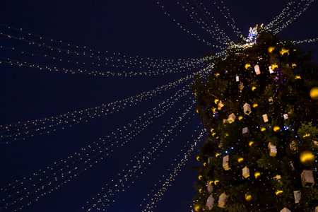 Street city Christmas tree at night. Holiday decorations and lights. Garland of lights.の写真素材