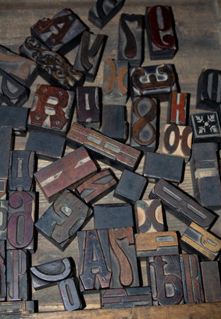 Set of old wooden letters for typography. Vintage background. Letter stamp for printing books in the...