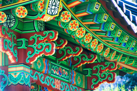Pagoda. Close-up fragment of a bright wooden gazebo in the garden. Multicolored pattern.