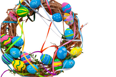 Easter wreath of vines and colored eggs isolated on white background. Festive decor on the door and in the house. Decorated egg - Pysanka.の写真素材