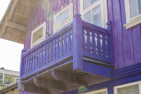 Wooden balcony of a wood house. Exterior facade. Blue colorの写真素材