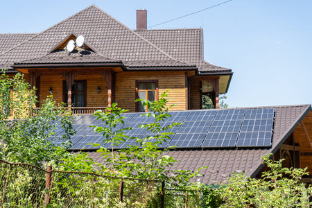 Solar panels on the roof of a residential building wooden house in a village.