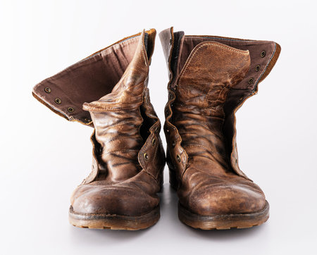 Old shoes on a white background. Leather brown shoe. Worn shoes.