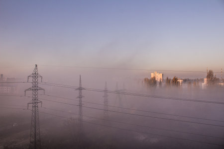 Fog and smog in the city. Power line. Pole wires. Power line top view from the window. Morning in the sleeping area.の写真素材
