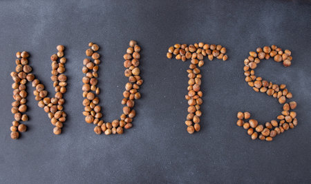 Word text Nuts. Hazelnut food background.の写真素材