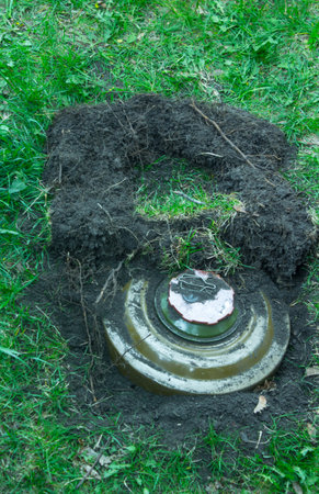 Green anti tank mine on the grass in the ground.の写真素材