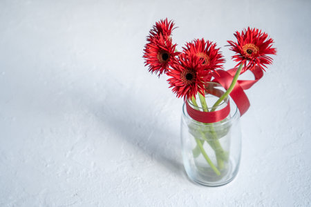 Gerbera Red Flowers in Glass Vaseの写真素材