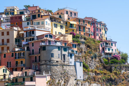 Multicolor houses building on cliff edge. Manarola Italian village Cinque Terre, Liguria, Italy. Summerの写真素材