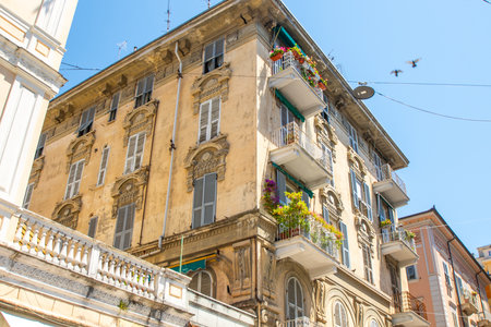 Yellow houses street in La Spezia city. Italian old town center. Old balcony architectureの写真素材