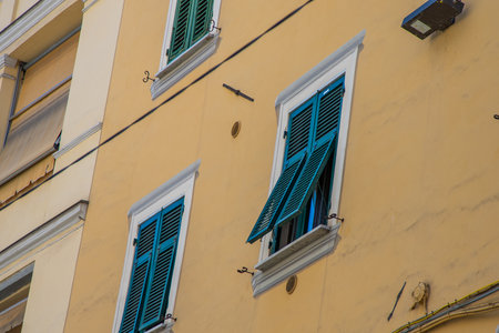 Italian shutters on the windows of the house. Open wooden shutter in summer.の写真素材