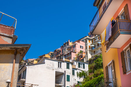 Italian shutters on the windows balcony multicolor house. Open wooden shutter in summer. Cinque...