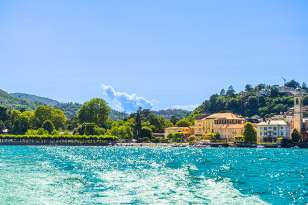 Old houses building architecture on lake Como, Italy. Blue wave and sky