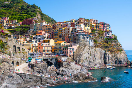 Multicolor houses on cliff edge. Manarola Italian village Cinque Terre, Liguria, Italy. Summer sea