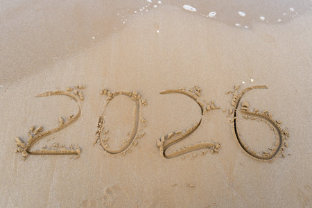 2026 numbers written in the sandy beachの写真素材