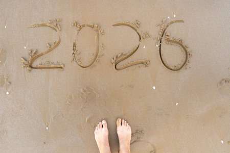 2026 numbers written in the sandの写真素材