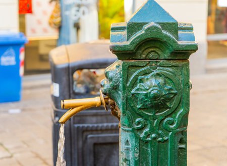 Old city fountain in Como Italy. Drinking tap water flows. Italian streetの写真素材