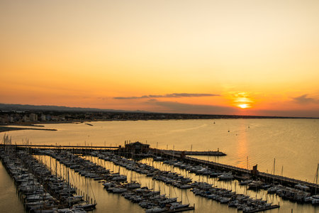 Yacht club top view. The sky in the evening. Water sea parking ships. Sunset sky at seaport of Italian city of Rimini in Summer.の写真素材