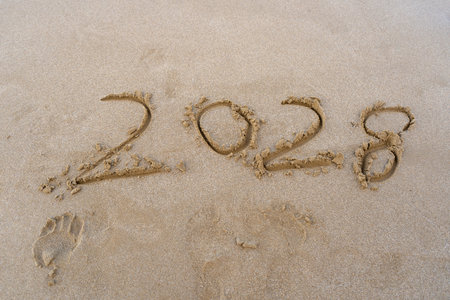 2028 numbers written on sand.
