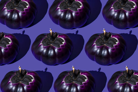 Pumpkin shaped eggplant on a purple background. Vegetable violet food