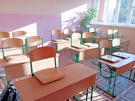 Empty classroom with desks and chairs at school.の写真素材