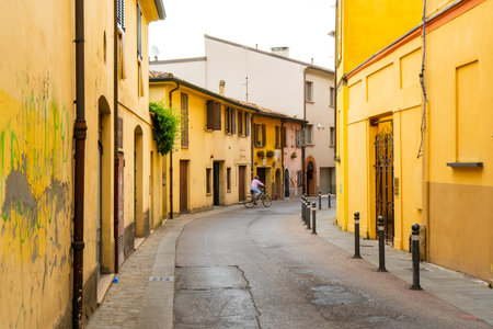 Old yellow narrow Italian street architecture. Colorful houses in Rimini city Italy