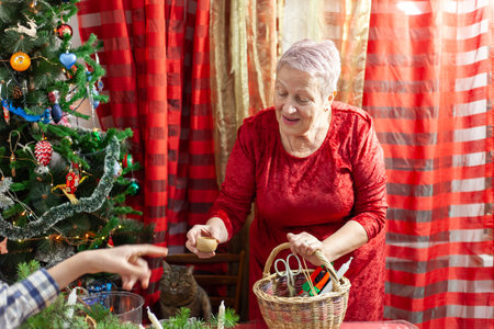 Grandmother Decorating Christmas Tree with Grandchildの写真素材