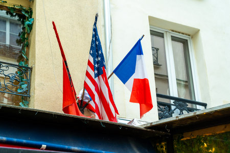The French and American flags on a building in Paris. Three flags.の写真素材