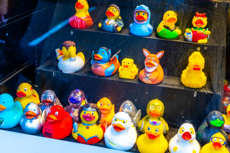 Yellow rubber Ducks different celebrity character cartoon in duck store. Souvenir toy on a shop windowのeditorial素材