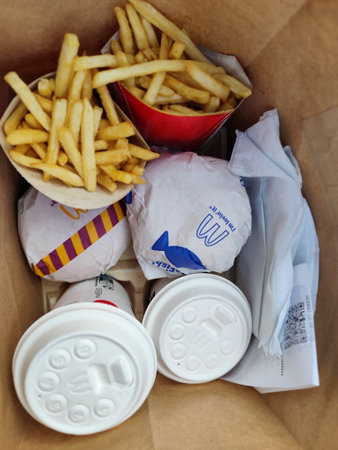 Menu order Mc Smart plus in McDonalds cafe. Burgers potatoes and drinks Food to go in paper bag.