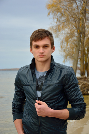 A young man in front of the sea の写真素材