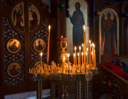 Candles in front of icons in the Orthodox church, decorated for Christmasのeditorial素材