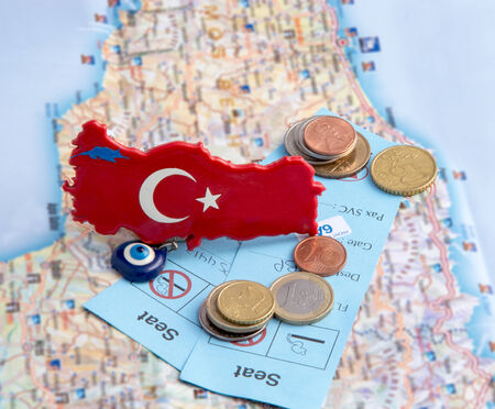 Magnet with Turkish symbols, coins and tickets on the mapの写真素材