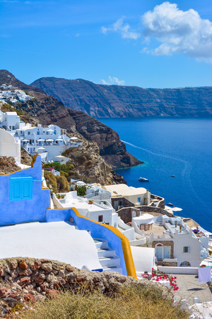 The traditional architecture of Santorini  White and blue houses the sunlit sea, cliff, the island of Santorini, Greece の写真素材