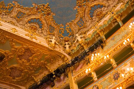 Editorial. May, 2019. Venice, Italy. Richly decorated ceiling fragment with sculptures in the auditorium of the La Fenice Theatre. Interior of the La Fenice Theatre. Venice, Italyのeditorial素材