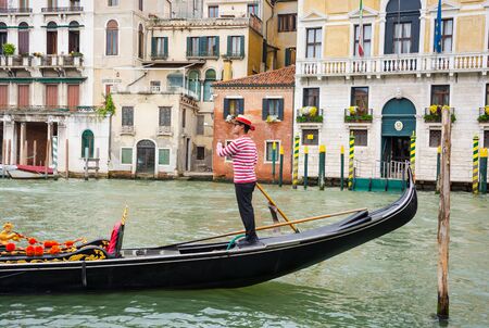 Editorial. June, 2019. Venice, Italy. View of the Grand Canal and a gondola in Venice, Italy. Gondolier on gondolas at the views of Venice backgroundのeditorial素材