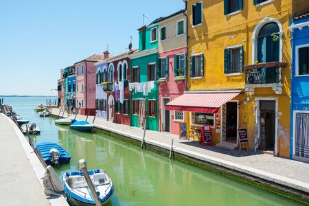 Editorial. June 2019. Burano island, Italy. View of the colored houses near the canal on the island of Burano, near Venice, Italyのeditorial素材