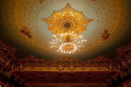 Editorial. May, 2019. Venice, Italy. Chandelier and paintings on the ceiling in the auditorium of the La Fenice Theatre. Interior of La Fenice Theatre.のeditorial素材