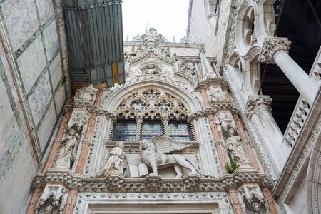Editorial. May, 2019. Venice, Italy. The architecture of the Doge's Palace from the courtyard - sculpture of the symbol of venice - winged lionのeditorial素材
