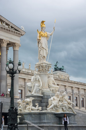 Editorial. 1 June, 2024. Vienna, Austria. Fountain of Pallas Athena near the Parliament House, built by Karl Kundmann in 1902, four bronze groups of horse tamers, created by Lax; a series of statues rising against the sky, as well as statues of Greek and のeditorial素材