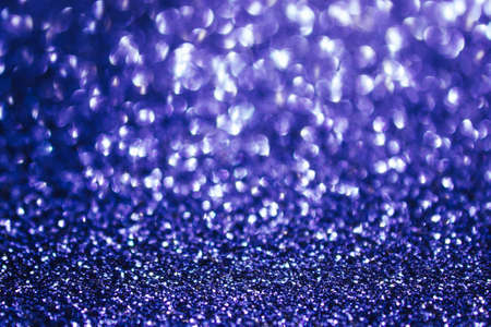 Ultraviolet abstract bokeh background, defocused Christmas lights. Festive concept. Selective focus.の写真素材