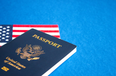 American flag and passport on blue background. Independence Day concept, 4th of July.