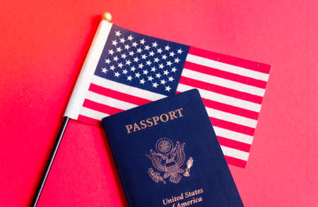 American flag and passport on red background. Independence Day concept, 4th of July.の写真素材