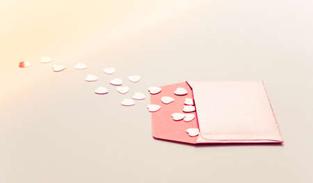 Valentine's Day background, concept, hearts and red envelope on beige.の写真素材