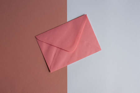 Pink envelope and cardboards on table. Mockup. Office concept.の写真素材