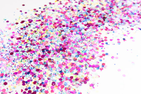 Sparkling and trandy holographic tinsels on white background. Festive concept. Place for design.